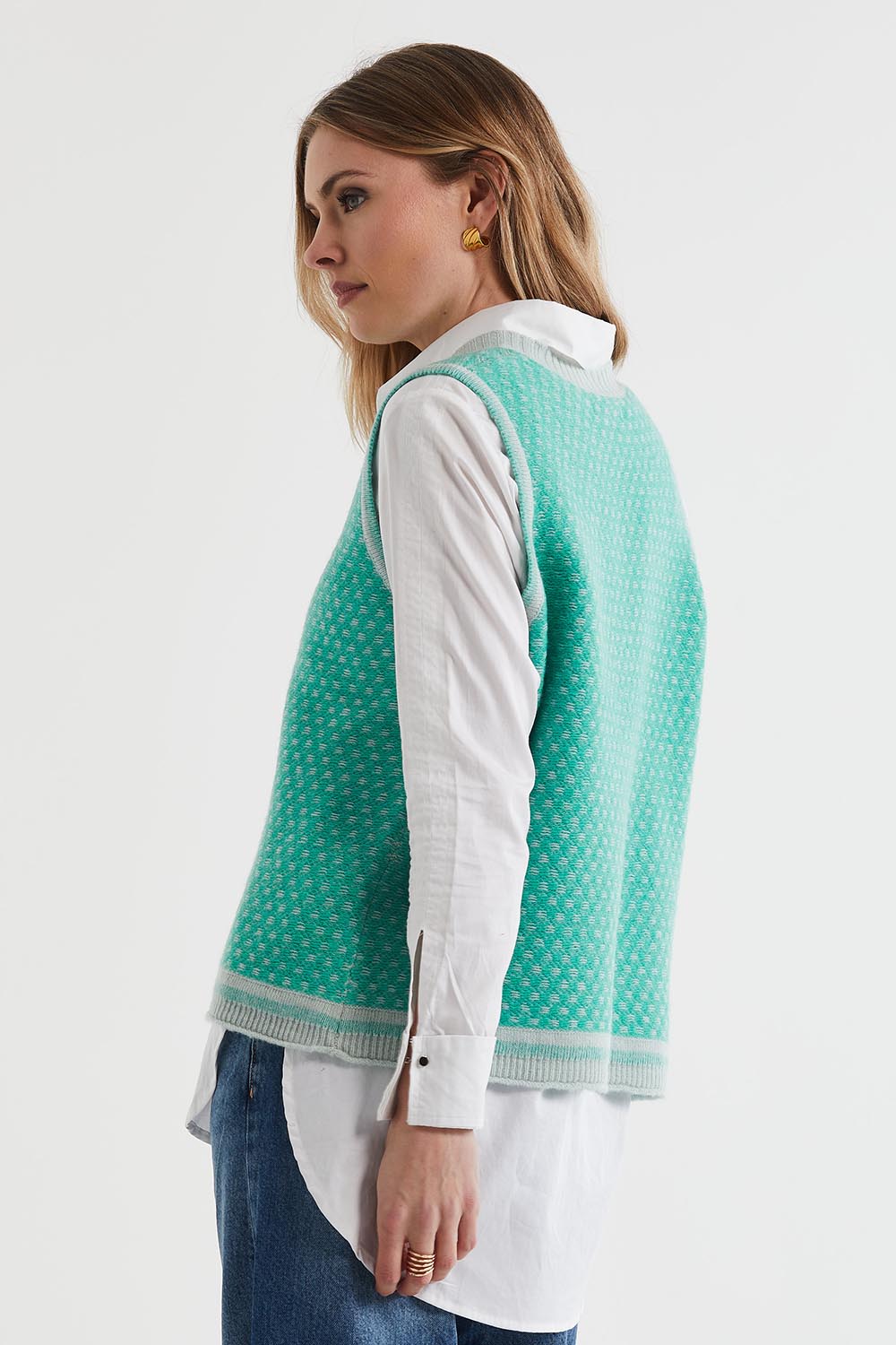 A model wearing the Lambswool Vest in colour Ice (Green), from the back