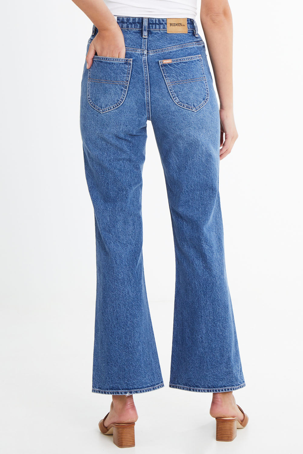 Model Madeline wearing size 10 of the Hi Flare in colour Goodvibes (Blue), from the back