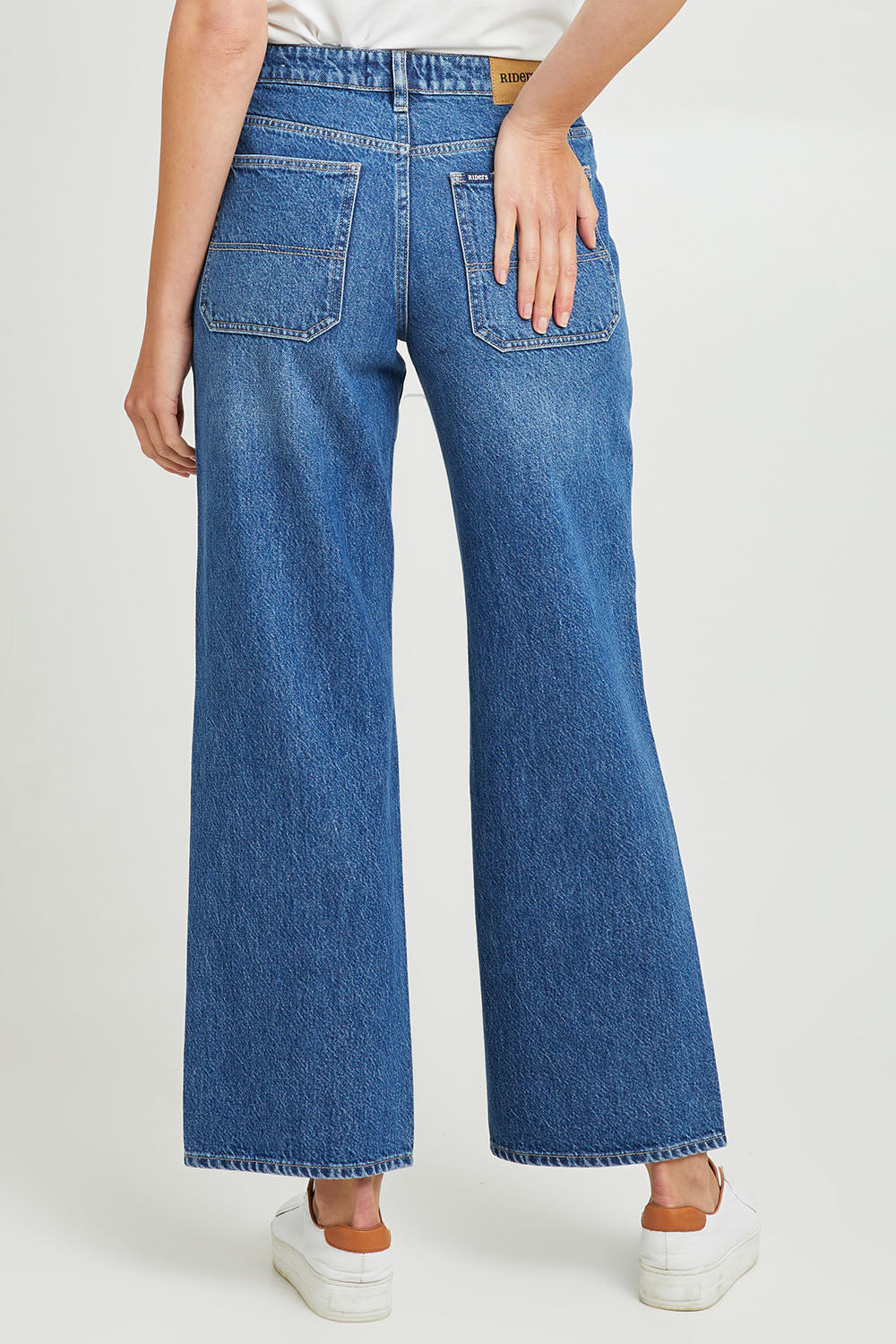 Model Madeline wearing size 10 of the Mid Vintage Wide Leg in colour Indigo (Blue), from the back