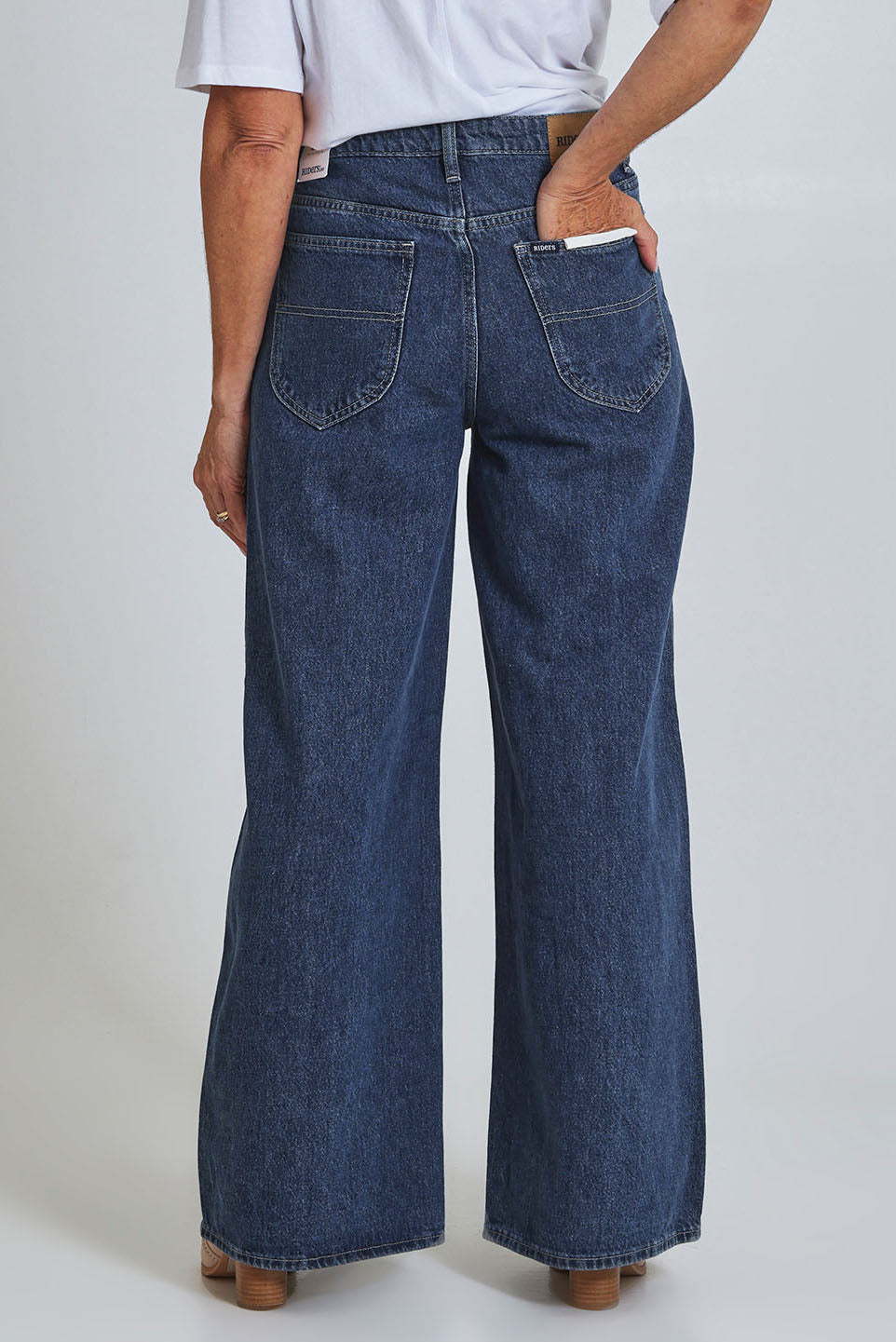 Model Sandy wearing size 10 of the Riders Mid Ain colourLine Wide Leg Jean - Bluehorizo (Blue), from the back