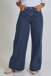 Model Sandy wearing size 10 of the Riders Mid Ain colourLine Wide Leg Jean - Bluehorizo (Blue), from the front, cropped image