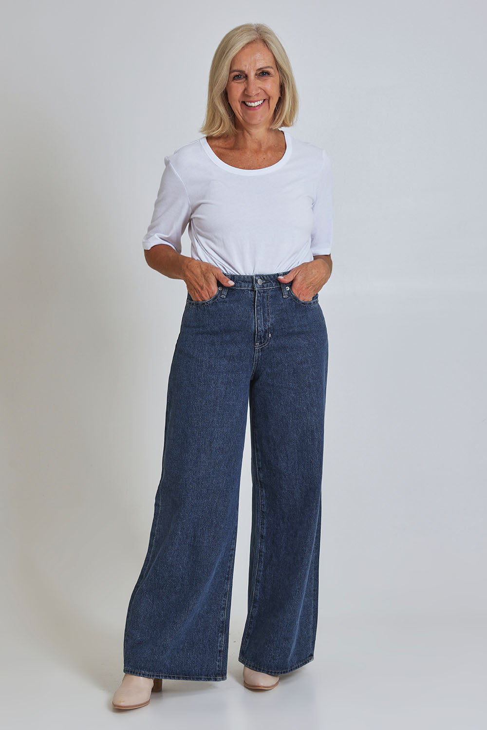 Model Sandy wearing size 10 of the Riders Mid Ain colourLine Wide Leg Jean - Bluehorizo (Blue), from the front, showing the whole outfit