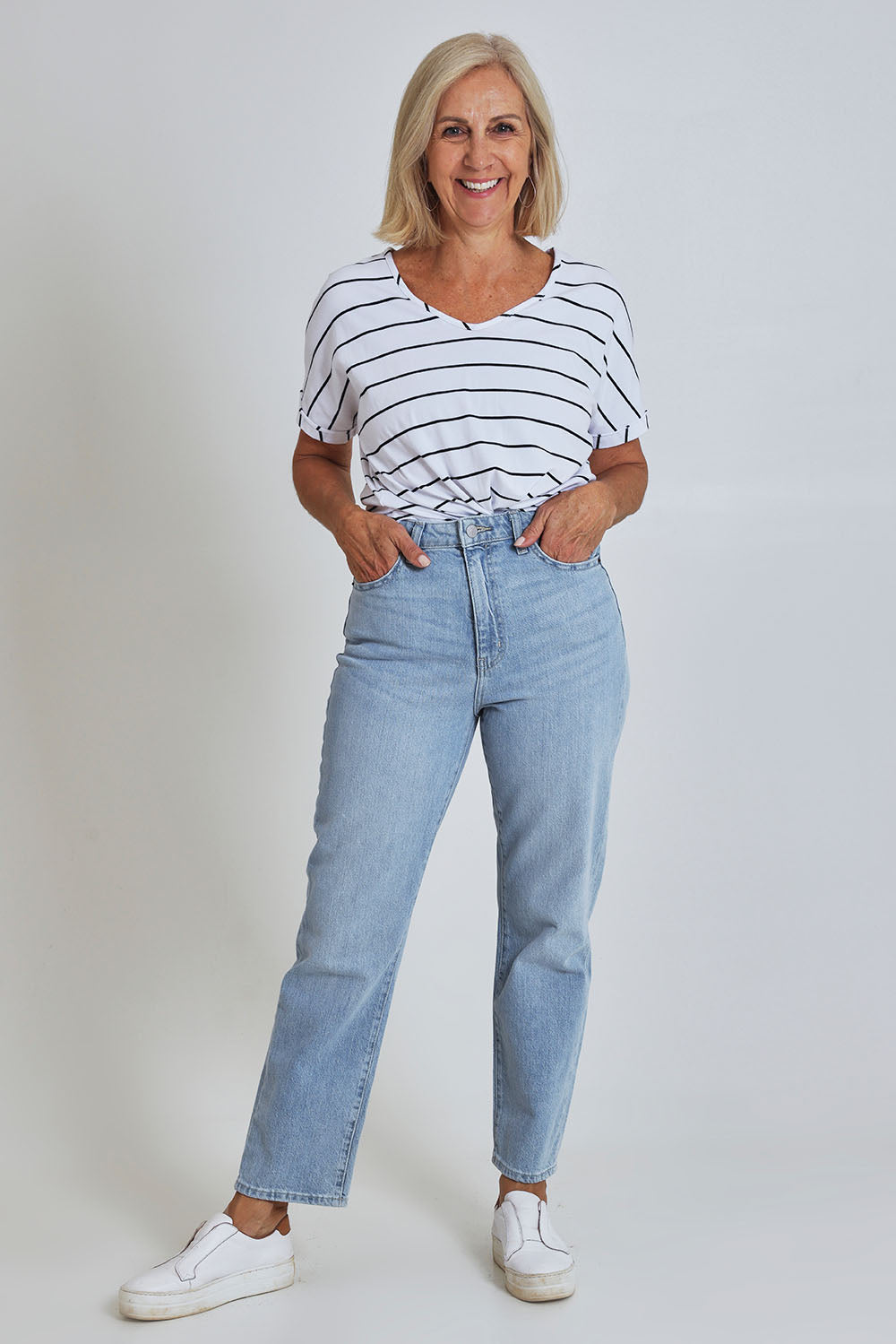 Model Sandy wearing size 10 of the Riders Hi Straight Leg Jean in colour Fadedblue (Blue), from the front, showing the whole outfit