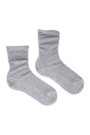 Product shot of the Rib Midi Sock in colour Greymarle (Grey), from the front