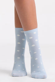 A model wearing the Gigi Spot Sock in colour Capri (Blue), from the front, cropped image