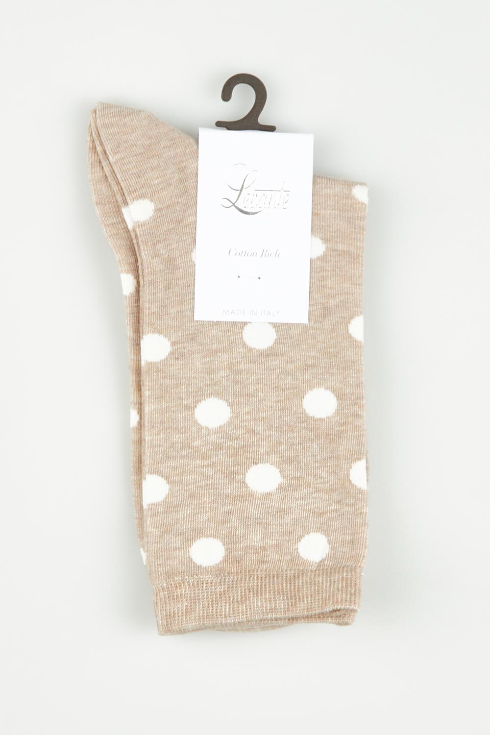 A model wearing size OneSize of the Gigi Spot Sock in colour Oatmeal, from the front, showing the whole outfit