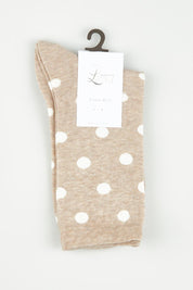A model wearing size OneSize of the Gigi Spot Sock in colour Oatmeal, from the front, showing the whole outfit