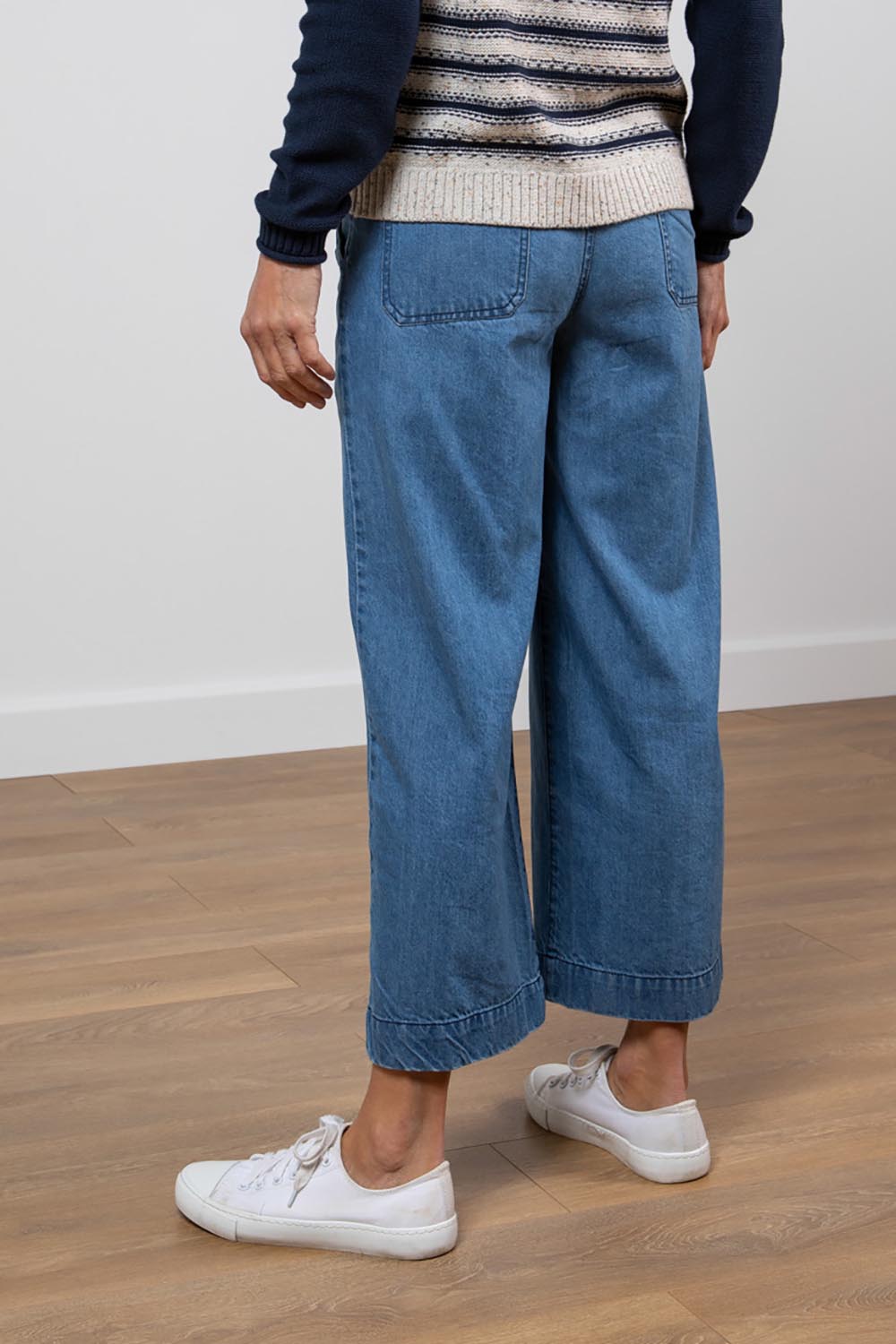 A model wearing the Ruby Crop Jeans in colour Denim (Blue), from the back
