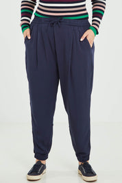 Model Jess wearing size 16 of the Tetbury Trouser in colour Navy (Blue), from the front, cropped image