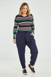 Model Jess wearing size 16 of the Tetbury Trouser in colour Navy (Blue), from the front, showing the whole outfit