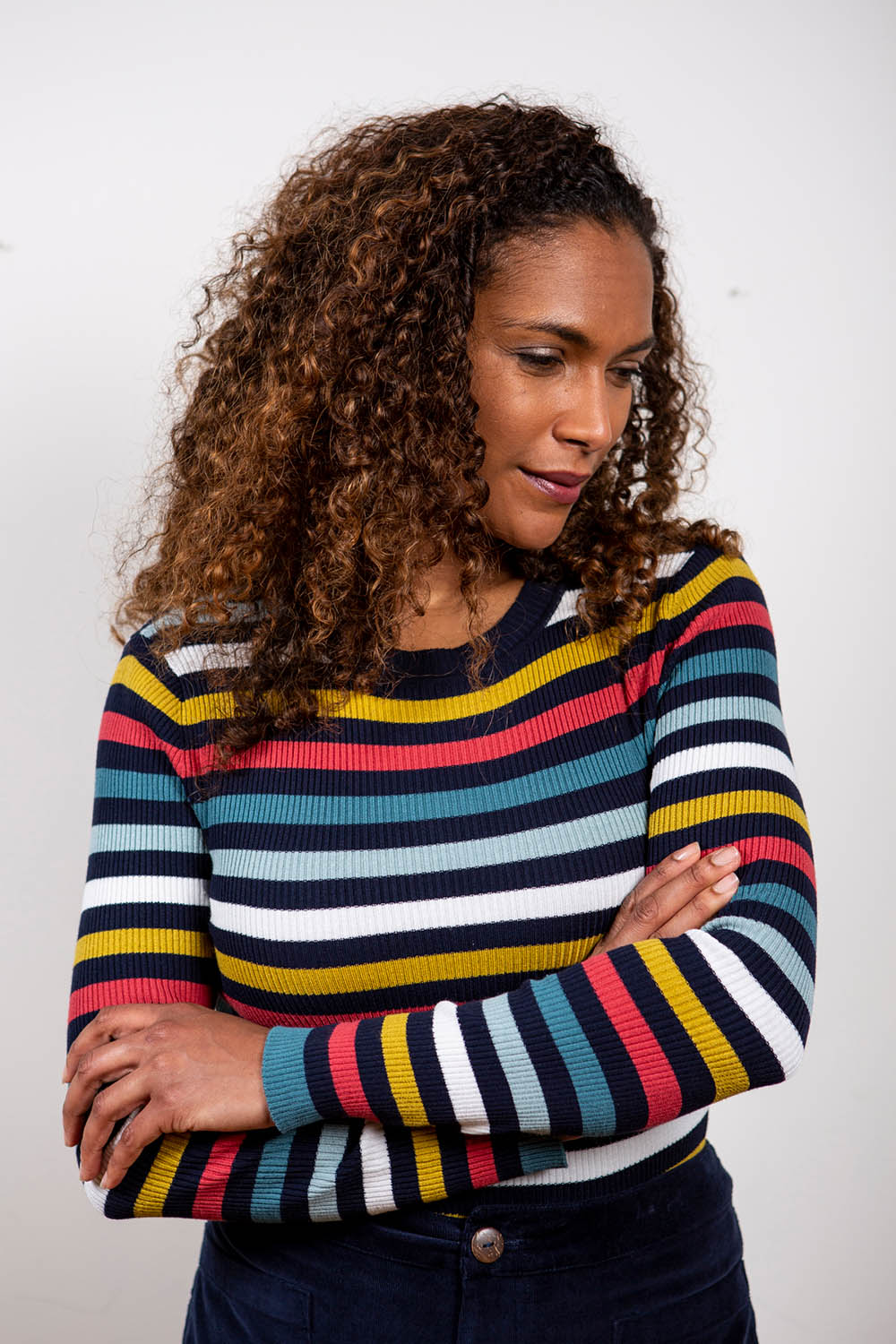 A model wearing the Stripe Ribbed Crew Neck Jumper in colour Ochre (Black), from the front, showing the whole outfit