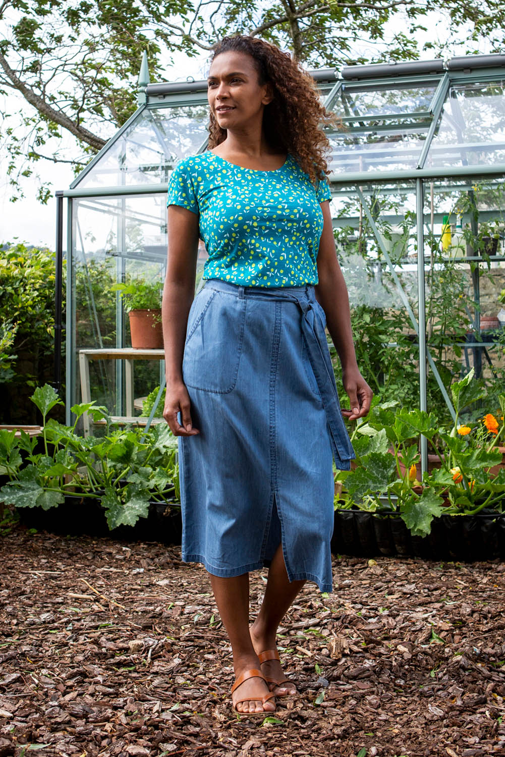 A model wearing the Cowslip Skirt in colour Denim (Blue), from the front, showing the whole outfit