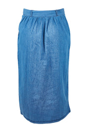 Product shot of the Cowslip Skirt in colour Denim (Blue), from the back
