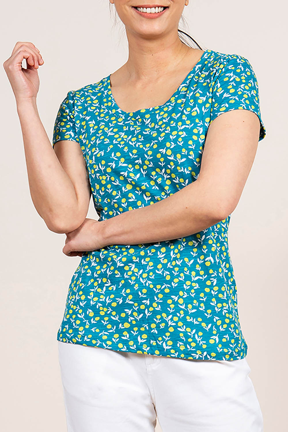 A model wearing the Cockles Tee in colour Teal (Blue), from the front, cropped image