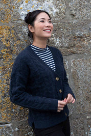 A model wearing the Ridgemont Cardi in colour Navy (Blue), from the front, showing the whole outfit