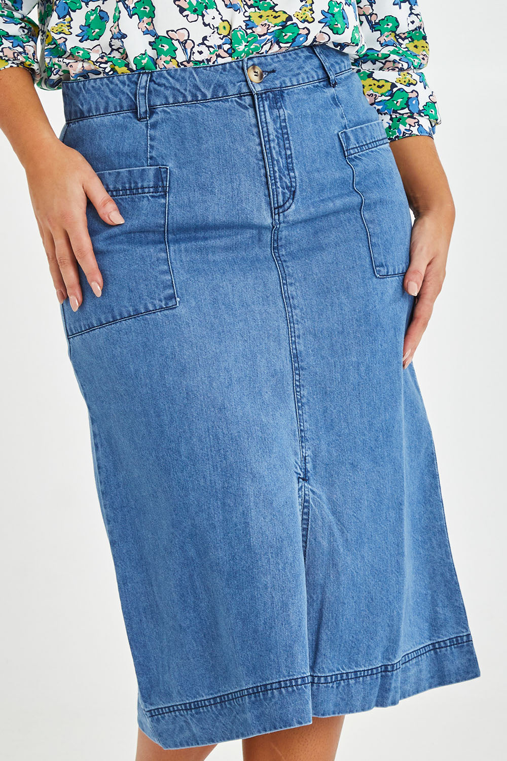 Model Monique wearing size 14 of the Penrose Skirt in colour Denim (Blue), from the front, cropped image