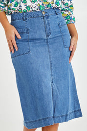 Model Monique wearing size 14 of the Penrose Skirt in colour Denim (Blue), from the front, cropped image