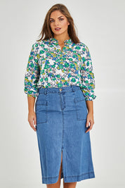 Model Monique wearing size 14 of the Penrose Skirt in colour Denim (Blue), from the front, cropped image