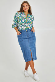 Model Monique wearing size 14 of the Penrose Skirt in colour Denim (Blue), from the front, showing the whole outfit