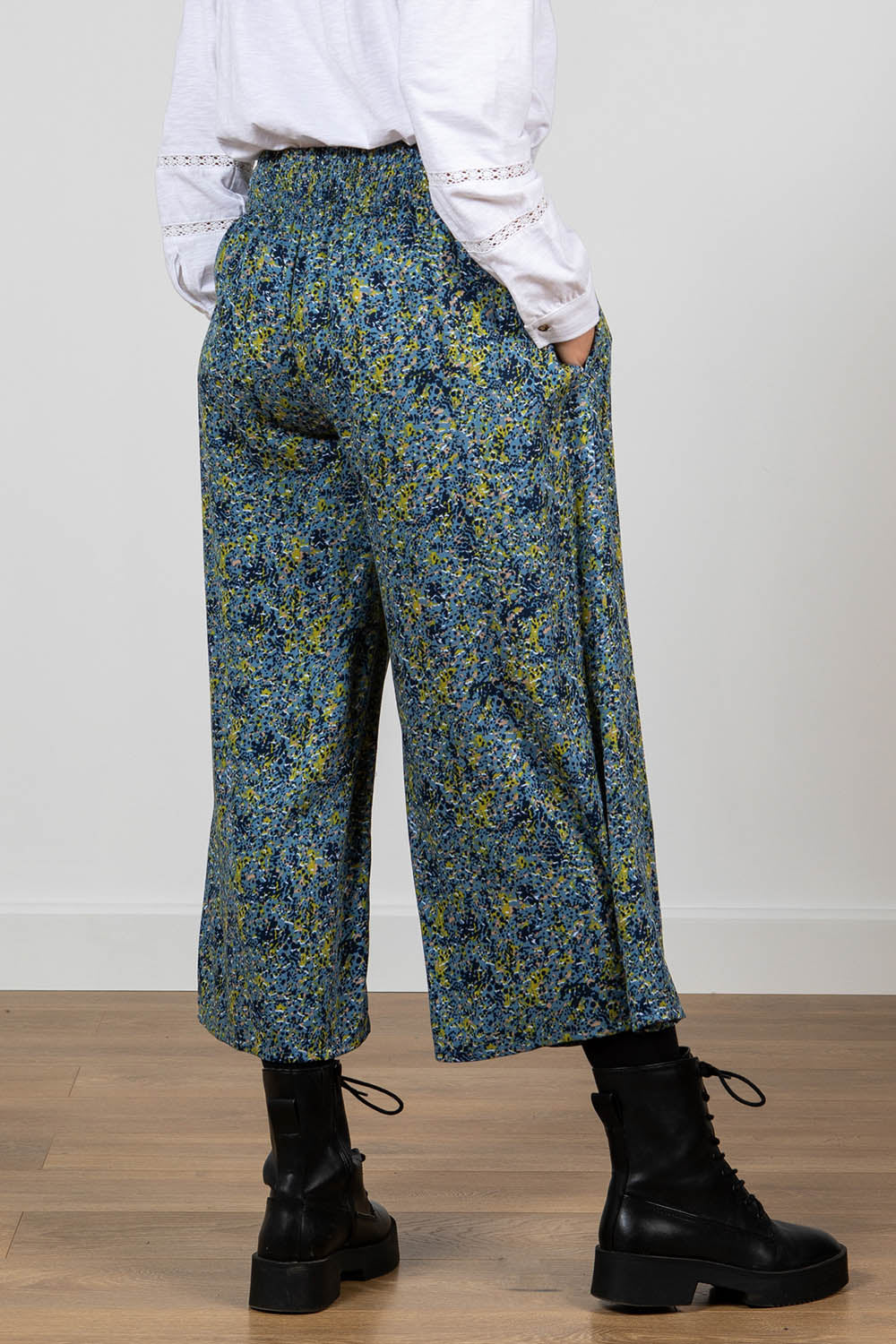 A model wearing the Elouise Trouser in colour Navy (Blue), from the back
