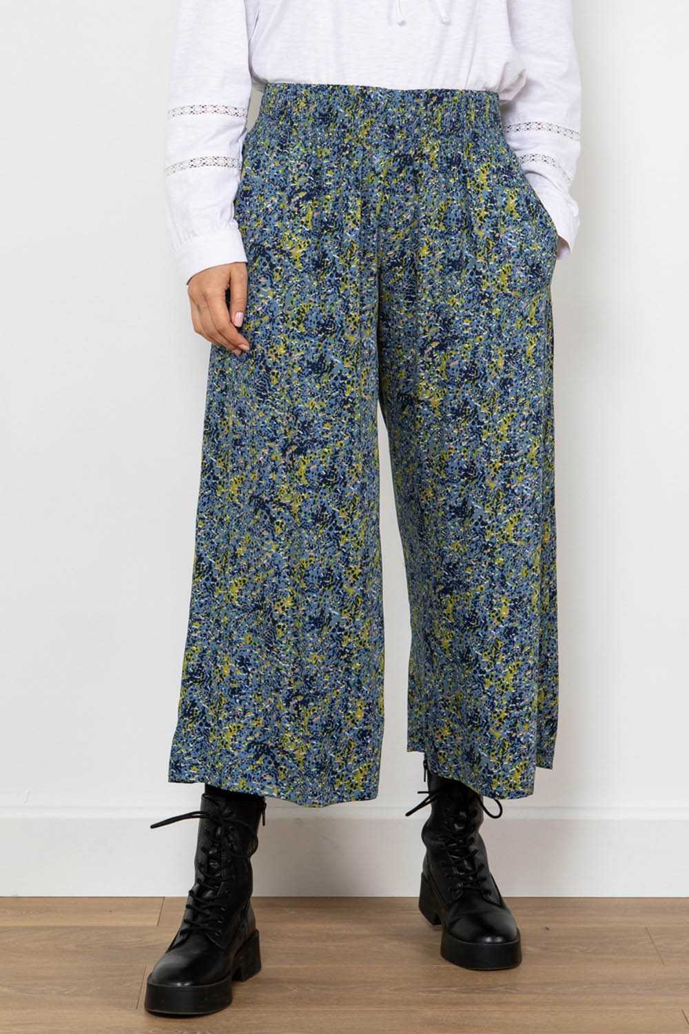 A model wearing the Elouise Trouser in colour Navy (Blue), from the front, cropped image