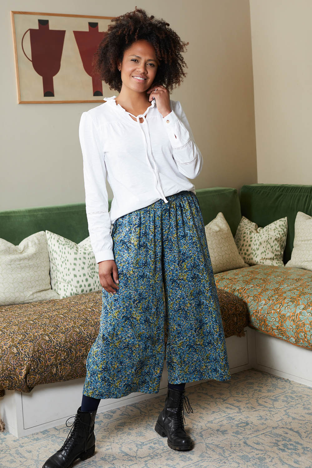 A model wearing the Elouise Trouser in colour Navy (Blue), from the front, showing the whole outfit