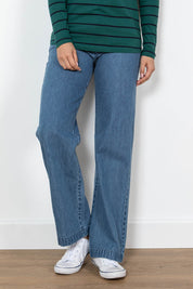 A model wearing the Oaksey Trouser in colour Denim (Blue), from the front, cropped image