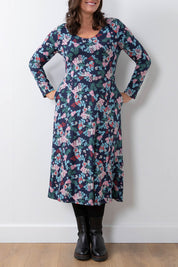 A model wearing the Jersey Swing Dress in colour Folkfloral (Blue), from the front, cropped image