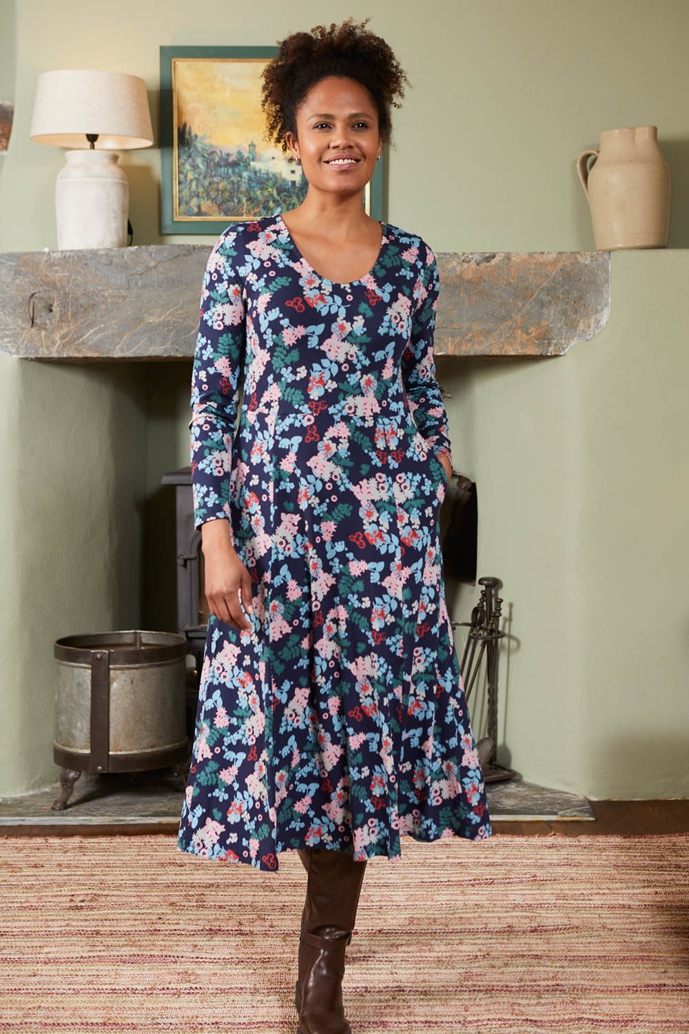 A model wearing the Jersey Swing Dress in colour Folkfloral (Blue), from the front, showing the whole outfit
