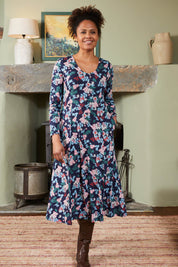 A model wearing the Jersey Swing Dress in colour Folkfloral (Blue), from the front, showing the whole outfit