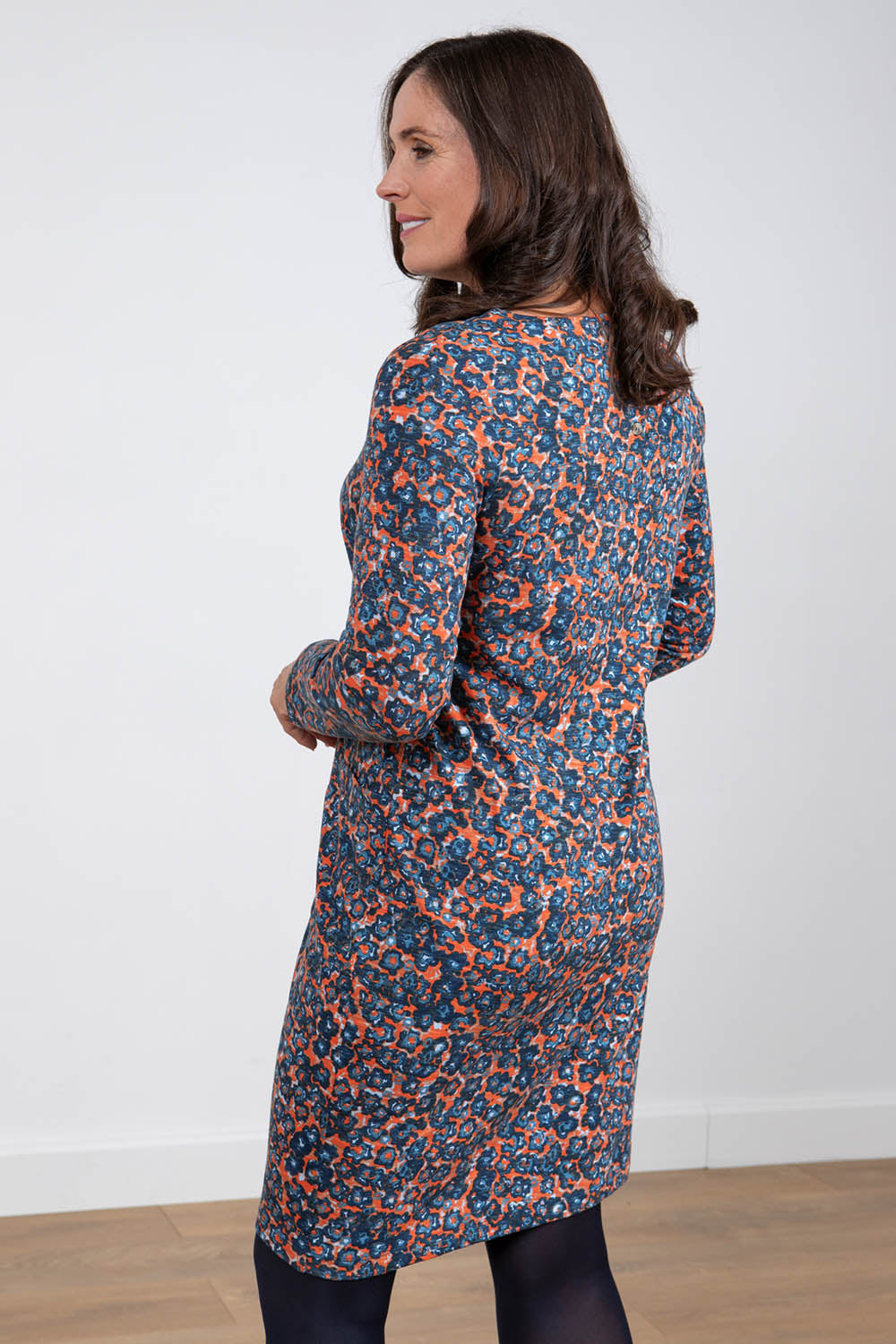 A model wearing the Maisemore Dress in colour Floret (Blue), from the back