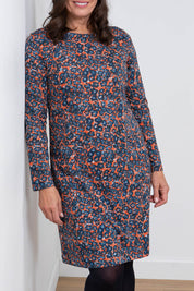 A model wearing the Maisemore Dress in colour Floret (Blue), from the front, cropped image