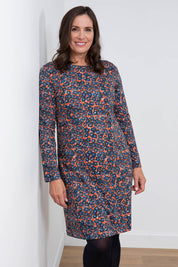 A model wearing the Maisemore Dress in colour Floret (Blue), from the front, cropped image