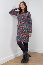 A model wearing the Maisemore Dress in colour Floret (Blue), from the front, showing the whole outfit