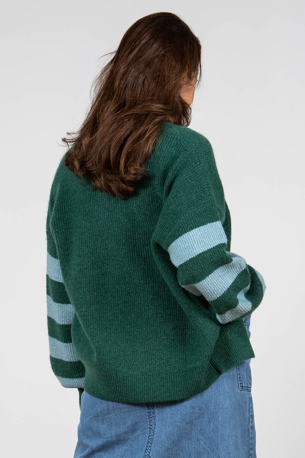 A model wearing the Skylore Rib Cardi in colour Green (Green), from the back