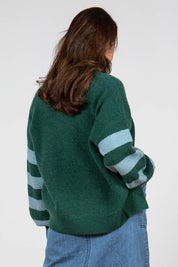 A model wearing the Skylore Rib Cardi in colour Green (Green), from the back