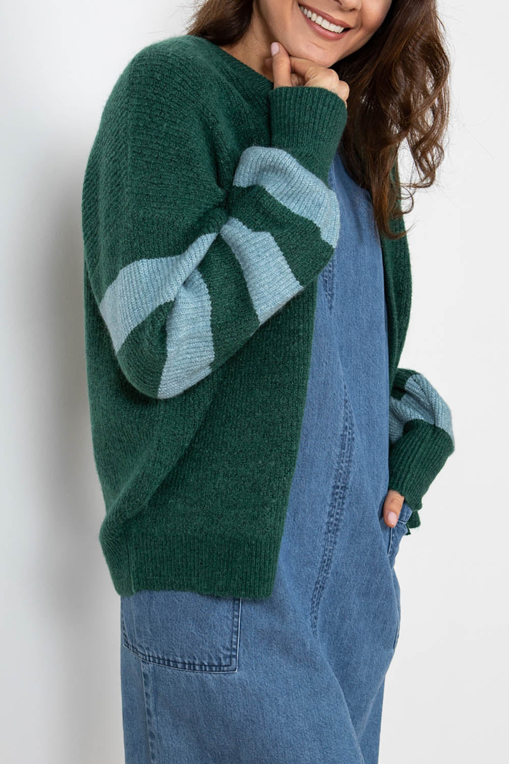 A model wearing the Skylore Rib Cardi in colour Green (Green), from the front, cropped image