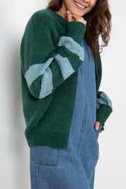 A model wearing the Skylore Rib Cardi in colour Green (Green), from the front, cropped image