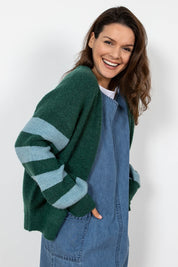 A model wearing the Skylore Rib Cardi in colour Green (Green), from the front, cropped image