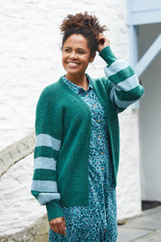 A model wearing the Skylore Rib Cardi in colour Green (Green), from the front, showing the whole outfit
