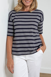 A model wearing the Blockley Top in colour Navy (Blue), from the front, cropped image
