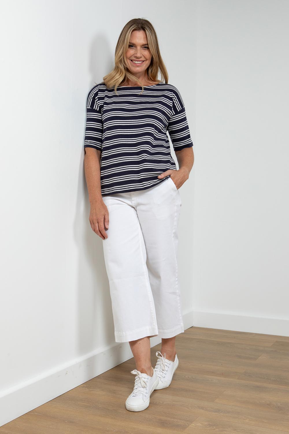 A model wearing the Blockley Top in colour Navy (Blue), from the front, showing the whole outfit