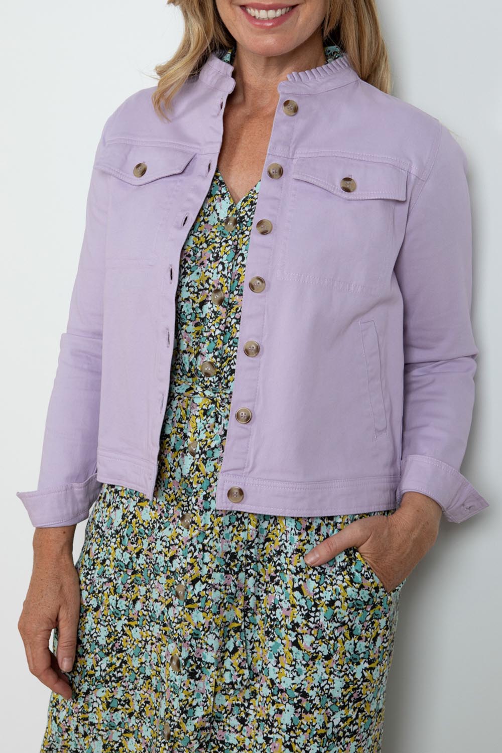 A model wearing the Clovelly Jacket in colour Lavender (Purple), from the front, cropped image
