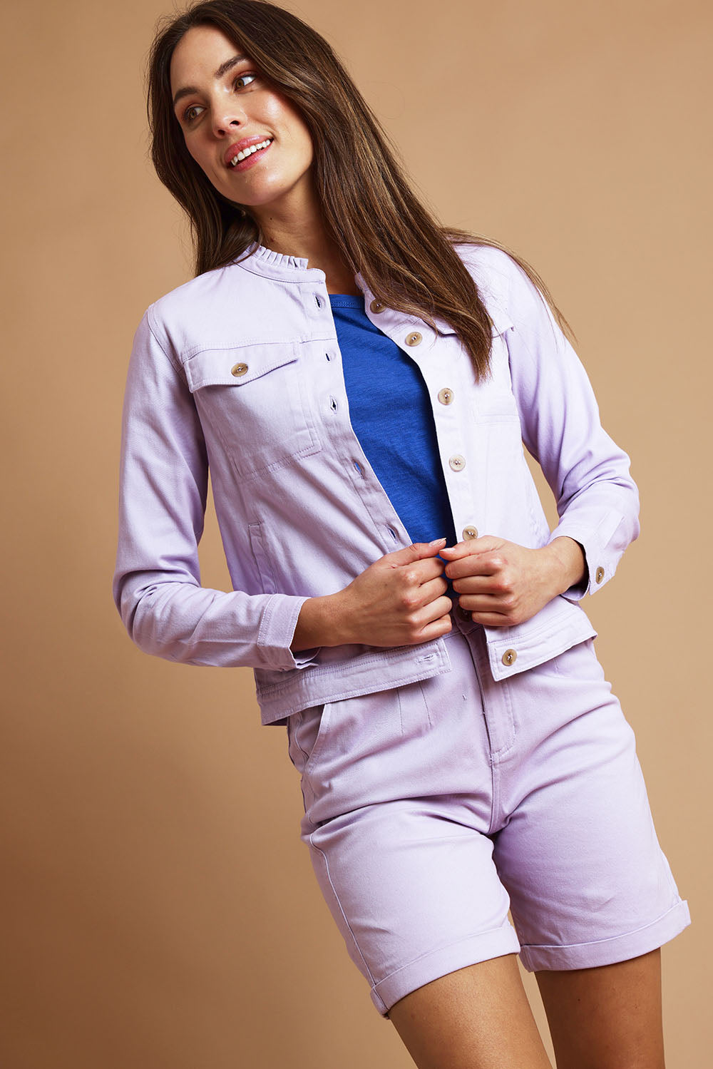 Model Madeline wearing size 10 of the Clovelly Jacket in colour Lavender (Purple), from the front, showing the whole outfit