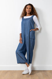 A model wearing the Edith Jumpsuit in colour Tencel (Blue), from the front, showing the whole outfit