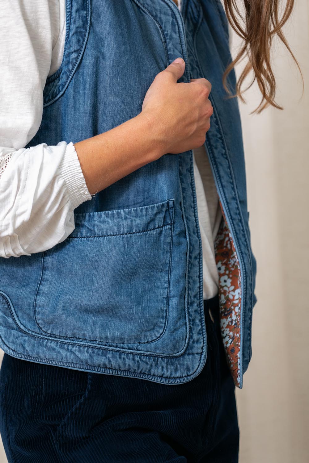 A model wearing the Deco Quilted Tencel Gilet in colour Blue (Blue), from the front, cropped image