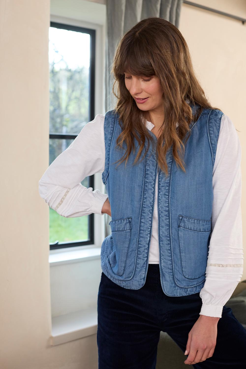 A model wearing the Deco Quilted Tencel Gilet in colour Blue (Blue), from the front, showing the whole outfit