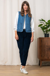 A model wearing the Deco Quilted Tencel Gilet in colour Blue (Blue), from the front, showing the whole outfit