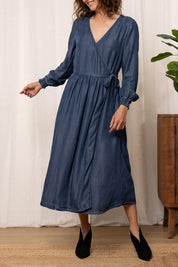 A model wearing the Christine Tencel Dress in colour Blue (Blue), from the front, cropped image