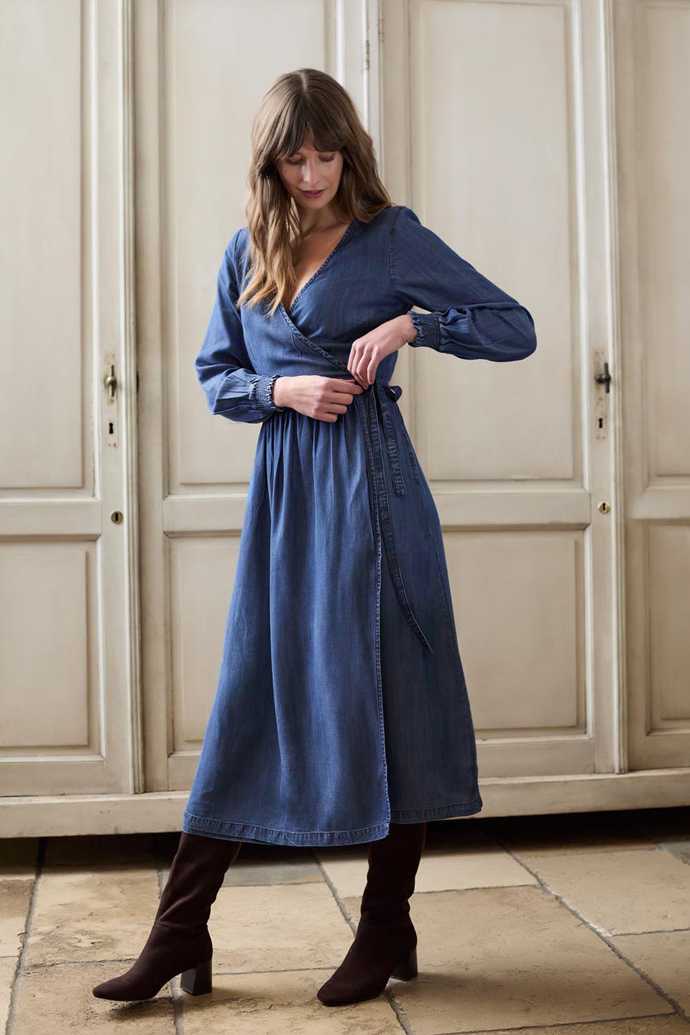 A model wearing the Christine Tencel Dress in colour Blue (Blue), from the front, showing the whole outfit